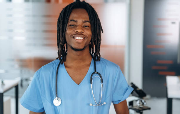 istock Standing and smiling. Black man doctor is in the office 2200200366