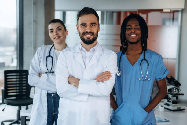 istock Three people are standing and posing. Doctors are in the clinic 2200200404