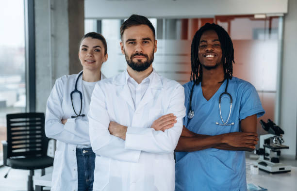 istock Three people are standing and posing. Doctors are in the clinic 2200200407