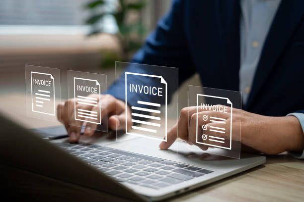 istock E-Invoice and Digital billing concept, Businessman using laptop to manage electronic statements on virtual screen. E-tax, Digital receipt, Online invoice processing and tax accounting solutions. 2200200783
