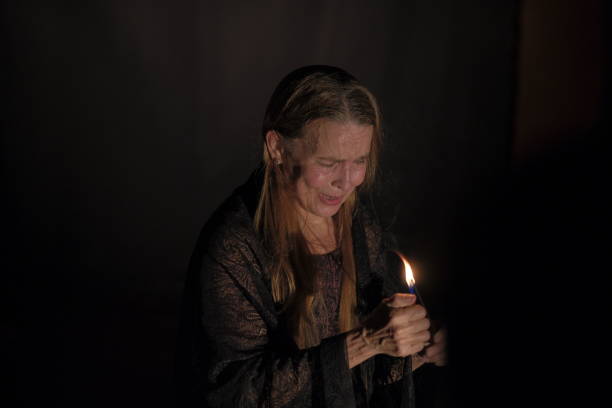 istock Older adult woman with dramatic gestures on theatrical stage. 2200201532
