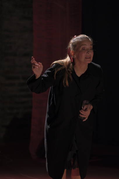 istock Older adult woman with dramatic gestures on theatrical stage. 2200201901
