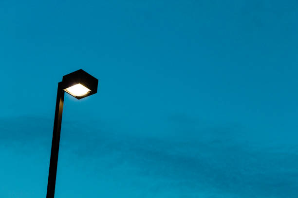 istock tall lamp lightpost high in the evening sky with space for copy background 2200203408