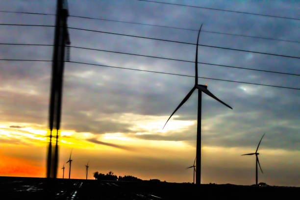 abstract motion blur windmill driving by american midwest wind turbine technology power energy sunset backdrop
