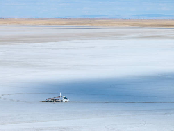 Aerial view of abandoned towing midibus stuck in the mud at Salt Lake in Konya Turkey. Taken by drone.