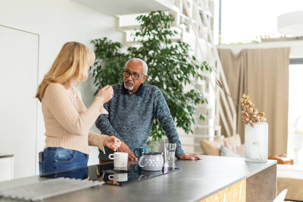 istock Senior Couple Having Coffee in Modern Kitchen 2200209288