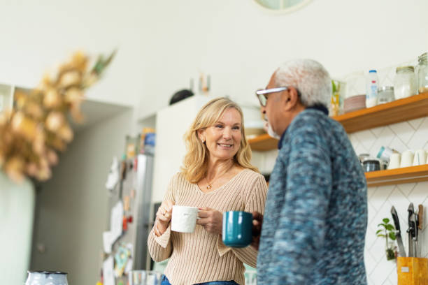 istock Senior Couple Enjoying Coffee in Modern Kitchen 2200209299