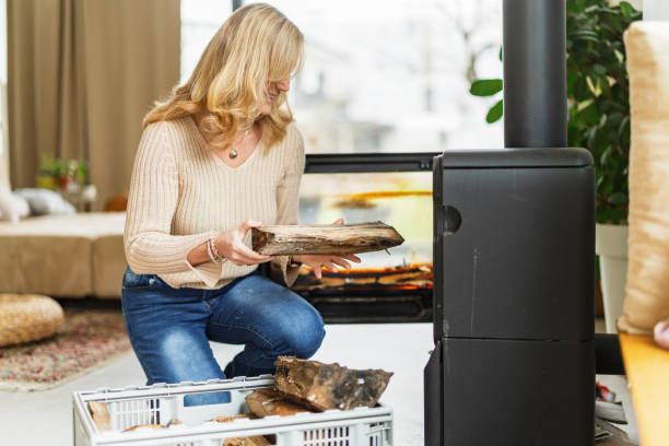 istock Senior Woman Adding Firewood at Home 2200209358