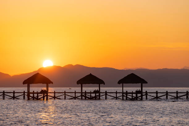 beautiful sunset with jetty silhouette in labuan bajo, indonesia.