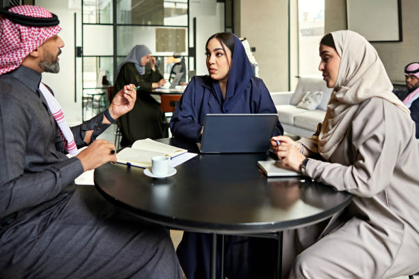 istock Saudi businesspeople debating ideas at coworking round table 2200212306