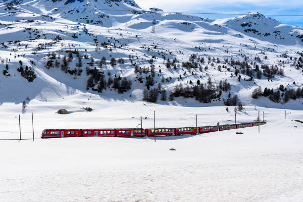 istock Electric passenger train running through a magnificent snowy mountain scenery 2200212937