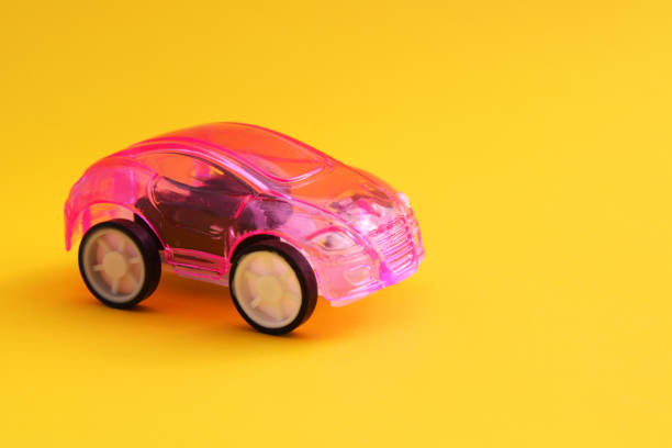 istock Pink car with yellow background 2200213185