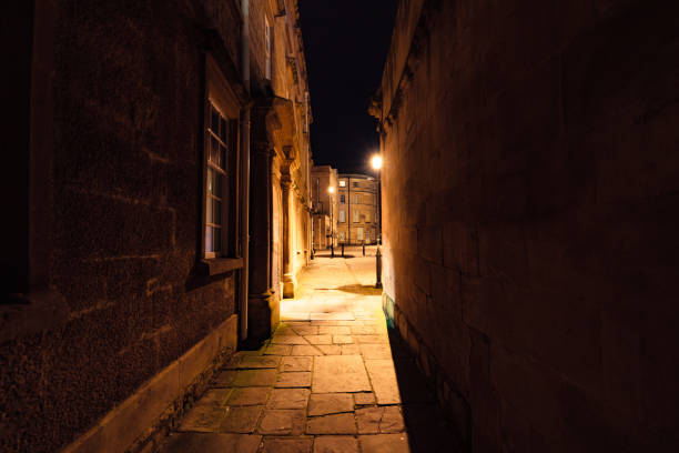istock Narrow cobbled street at night in bath, england 2200216982