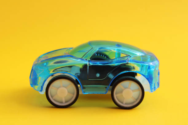 istock Transparent blue car with yellow background 2200217044