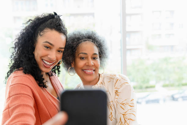 istock Happy Multiracial Mother and Daughter Taking a Selfie 2200217292