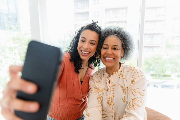 istock Happy Multiracial Mother and Daughter Taking a Selfie 2200217307