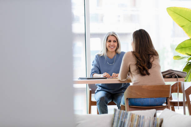 istock Two Women in Casual Clothes Having a Discussion 2200217325