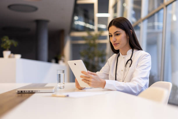 istock Young Latina doctor using a tablet for patient diagnosis 2200217827