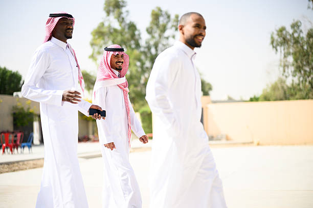 Middle Eastern men walking together in courtyard talking