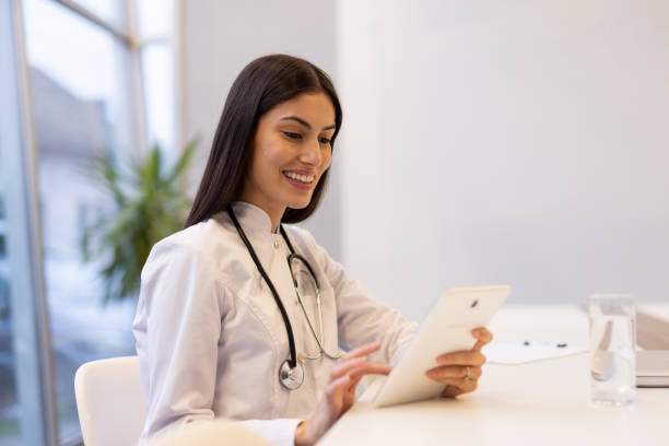istock Confident Latina physician managing patient care with a digital tablet 2200218855