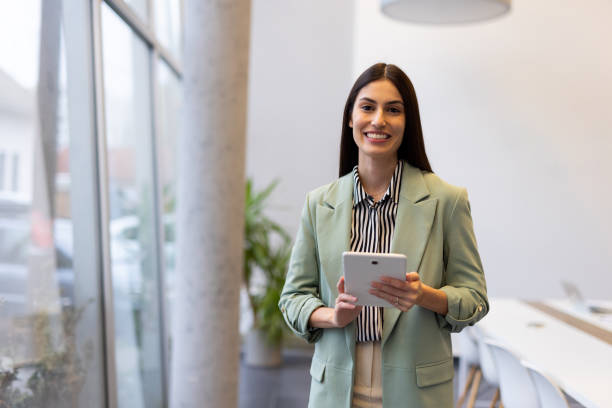 istock Focused Latina businesswoman analyzing data on a tablet in the office 2200219078