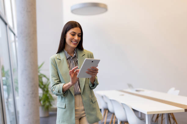 istock Smart Latina entrepreneur analyzing business trends on a tablet at work 2200219447