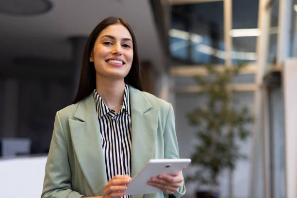 istock Latina professional checking emails on a tablet in a corporate environment 2200219448