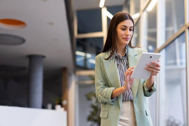 istock Smart Latina businesswoman using a tablet to organize her workday 2200220989