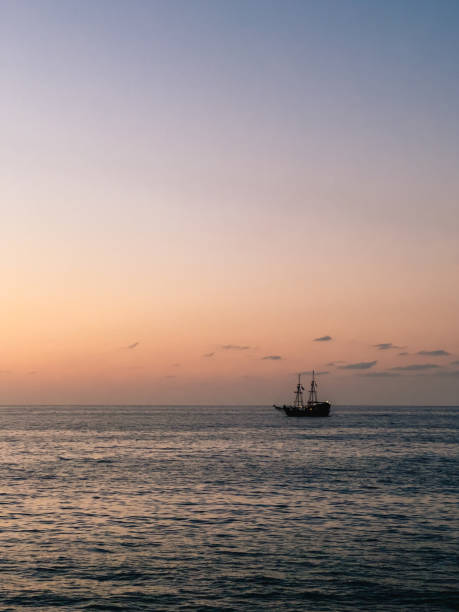 istock A Serene and Colorful Sunset Over a Tranquil Ocean Featuring a Charming Sailing Ship 2200221085