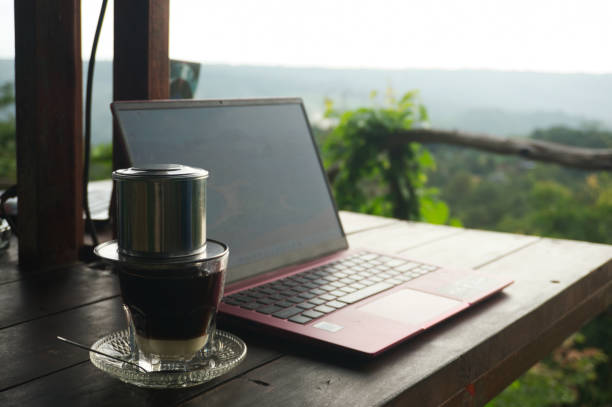 istock Laptop and Coffee in a Serene Natural Outdoor Workspace 2200221572