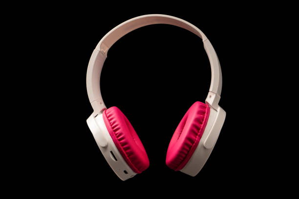 istock Pink and white headphones isolated on a black background. 2200222102