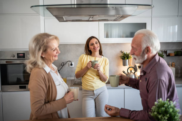 istock Daughter visiting elderly parents, drinking coffee in the kitchen 2200223417