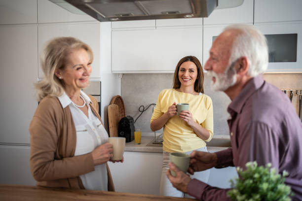 istock Daughter visiting elderly parents, drinking coffee in the kitchen 2200223419