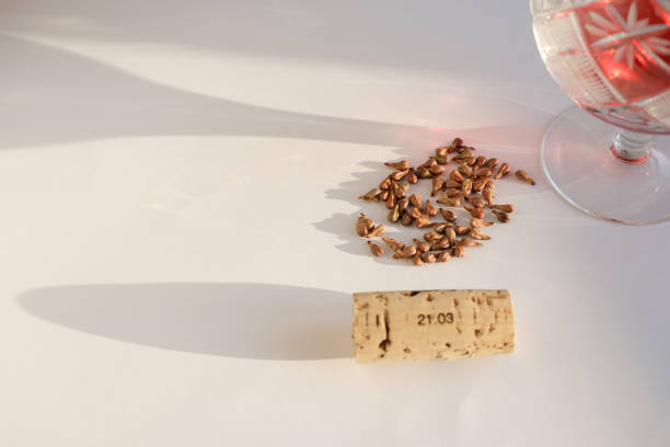 istock Grape seeds, wine cork, and crystal glass with red wine. 2200223845