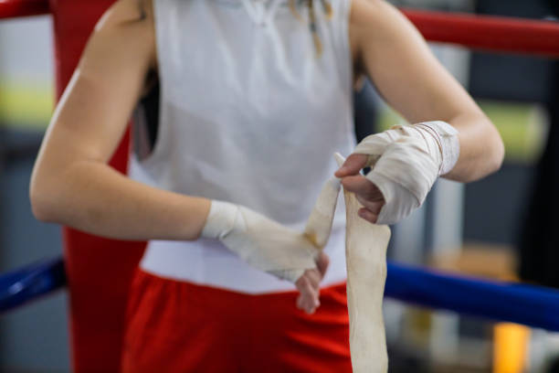 istock Fit young female boxer training with her male coach 2200224453