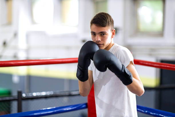 istock Young boxer training with her male coach 2200224626