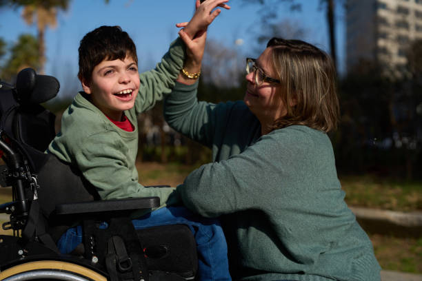 istock Happy disabled child giving high five to his mother 2200224632