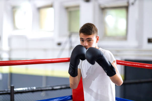 istock Young boxer training with her male coach 2200224639