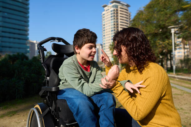 istock Happy child with disability communicating with sign language with his mother 2200224704