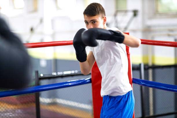 istock Young boxer training with her male coach 2200224767