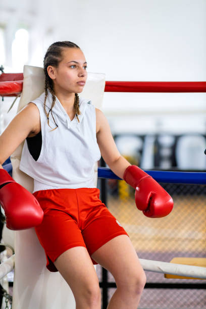 istock Fit female boxer training with her male coach 2200224849
