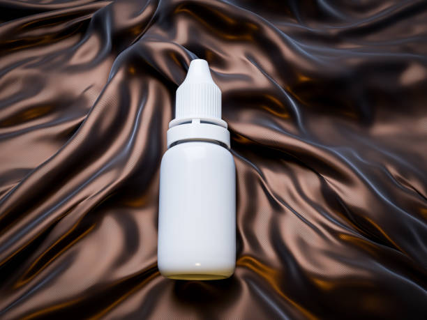 A clean, white plastic dropper bottle with a ribbed cap lies on elegant, flowing black satin fabric, highlighting a contrast between simplicity and luxury.