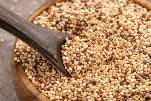 istock Rustic Wooden Spoon Scooping Tricolor Quinoa Grains 2200229534
