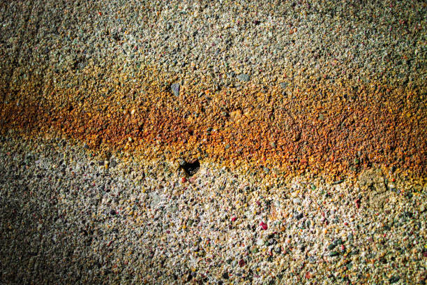abstract close-up of concrete with rust and erosion pitting spalling texture grunge surface detail background