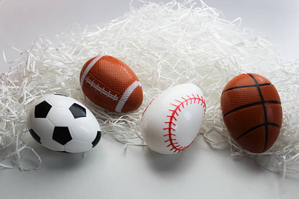 istock abstract Easter holiday spring summer recreation sign up sports backdrop graphic element plastic eggs representing soccer football baseball and basketball on white grass isolated 2200230069
