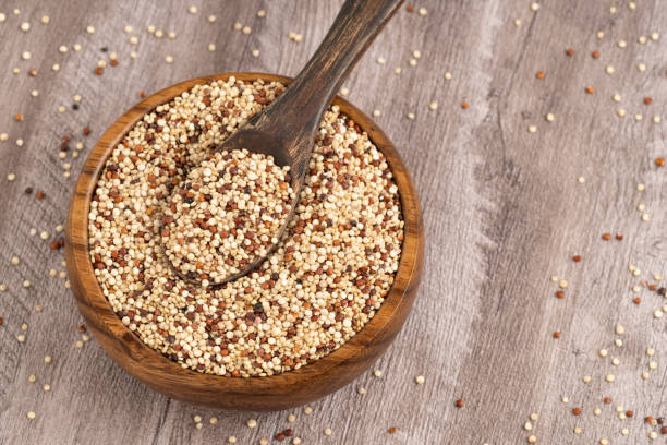 istock Wooden Bowl with Mixed Quinoa and Rustic Spoon on Wooden Surface 2200231410