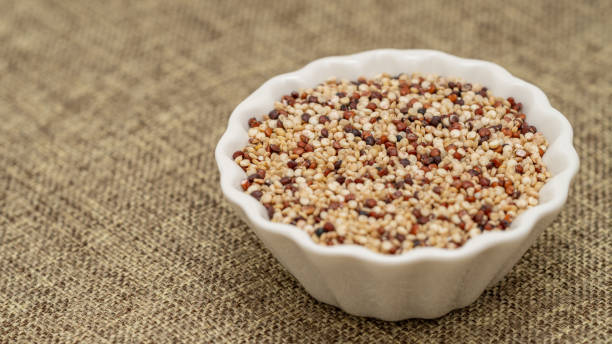 istock Bowl of Mixed Quinoa Seeds on Textured Fabric Background 2200231656