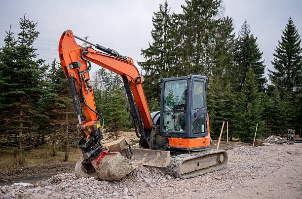 orange excavator with a hydraulic arm and bucket at construction site