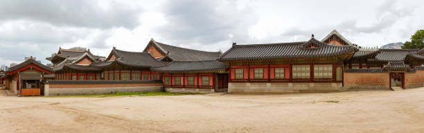 istock Traditional Korean Palace Complex Showcasing Historic Architecture With Ornate Roofs And Wooden Structures 2200233031