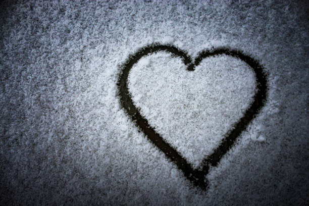 istock heart shape drawn in snow outline winter nature scene with copy space 2200236748